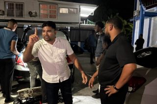 Mohamed, two staff members remain in custody as supporters protest